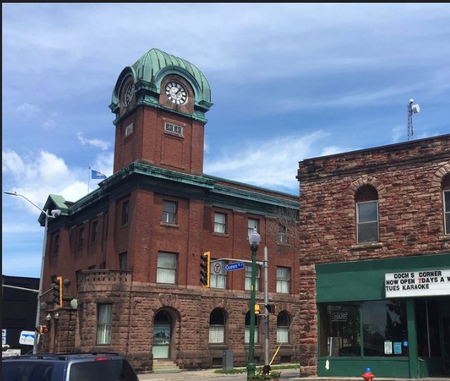 Historic clock tower and stone buildings in downtown Sault Ste. Marie